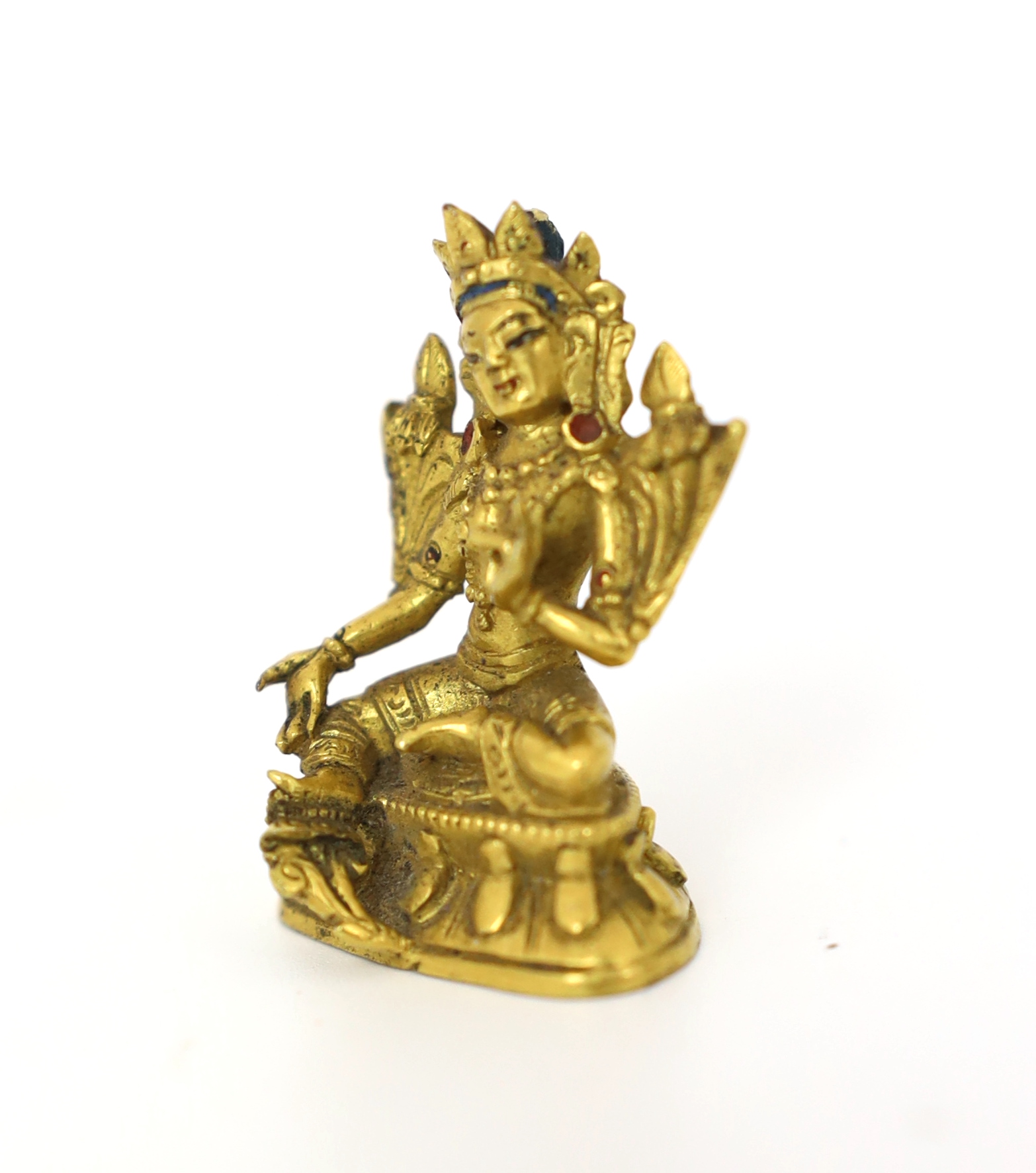 A Tibetan miniature gilt bronze figure of Green Tara, 18th/19th century, 3cm high, Provenance: G. Hawthorn Antiques, 22nd October 2007, Please note this lot attracts an additional import tax of 5% on the hammer price